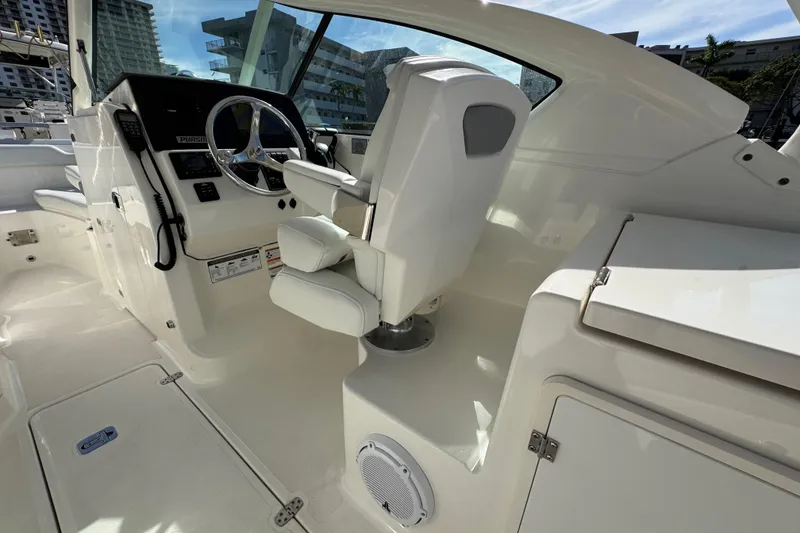 Slide: The Image of 2022 Pursuit DC 266 Dual Console boat interior with steering wheel and seating. - 50