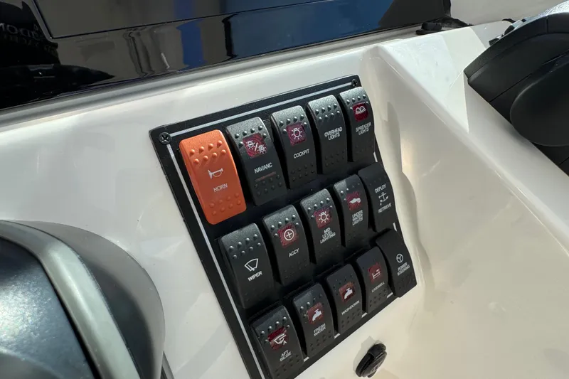 Slide: The Image of Control panel of 2022 Pursuit DC 266 Dual Console boat with labeled switches. - 59