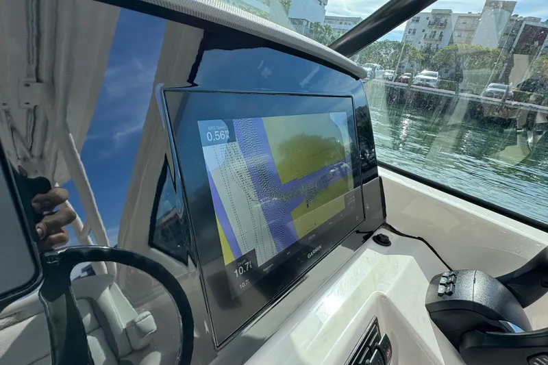 Slide: The Image of 2022 Pursuit DC 266 Dual Console boat dashboard with Garmin navigation display. - 60