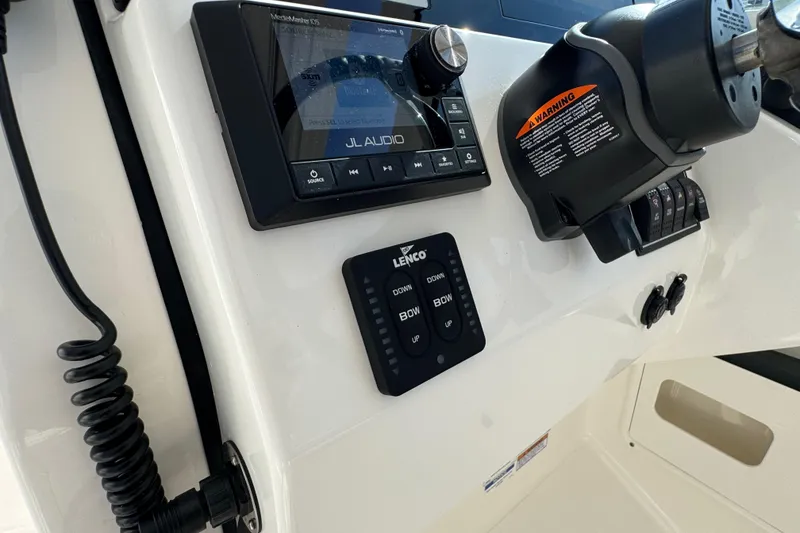 Slide: The Image of Control panel of 2022 Pursuit DC 266 Dual Console boat with JL Audio system. - 67