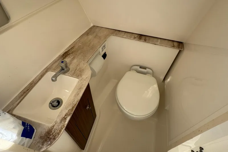 Slide: The Image of 2022 Pursuit DC 266 Dual Console boat bathroom with sink and toilet. - 69