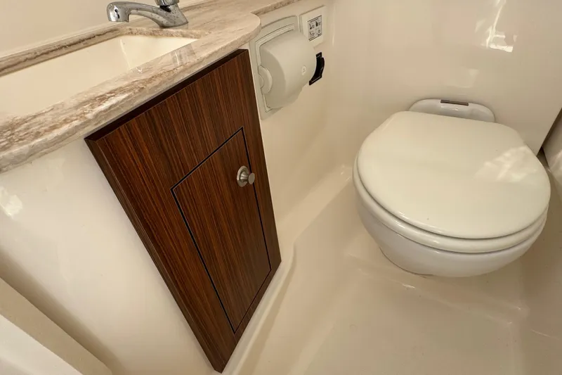 Slide: The Image of 2022 Pursuit DC 266 Dual Console boat bathroom with sink and toilet. - 73