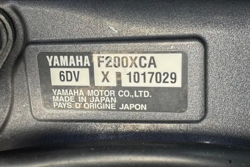 Slide: The Image of Yamaha F200XCA engine label on 2022 Pursuit DC 266 Dual Console boat. - 86