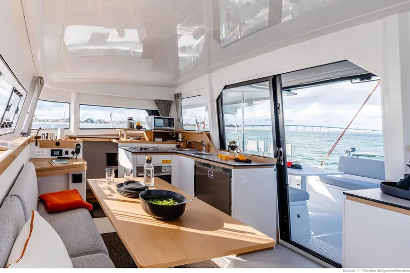 Slide: The Image of Luxurious interior of 2026 Excess 11 yacht with modern kitchen and dining area. - 19