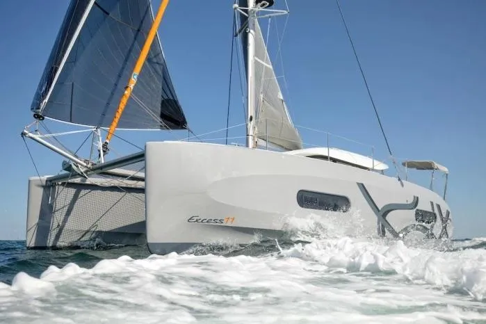 Slide: The Image of Manufacturer Provided Image: 2026 Excess 11 catamaran sailing on open water under clear blue sky. - 7