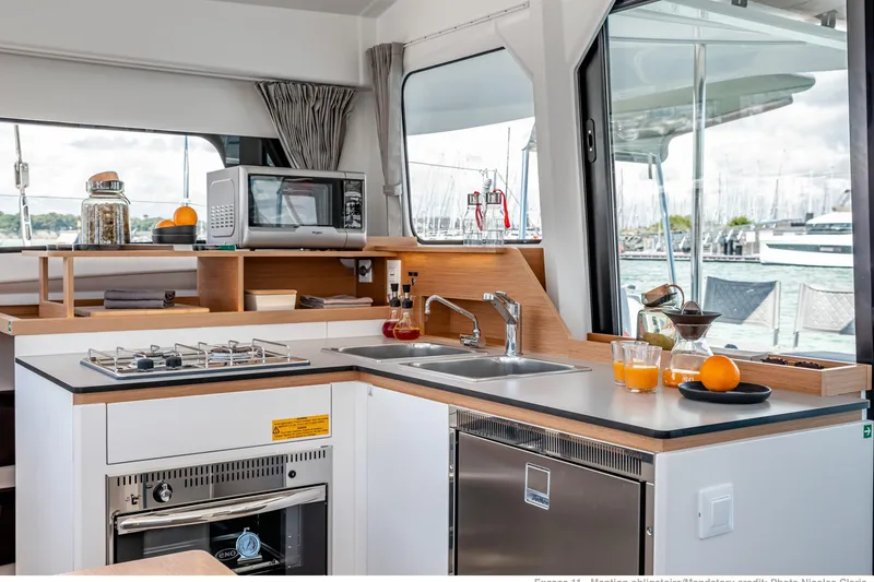 Slide: The Image of Modern kitchen interior on 2026 Excess 11 yacht with appliances and marina view. - 19