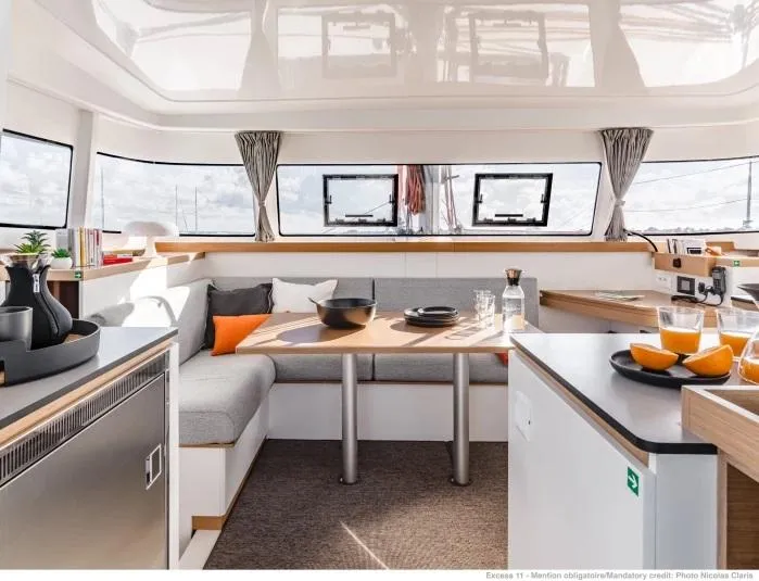 Slide: The Image of Manufacturer Provided Image: Modern interior of 2026 Excess 11 catamaran with dining area and kitchen. - 2