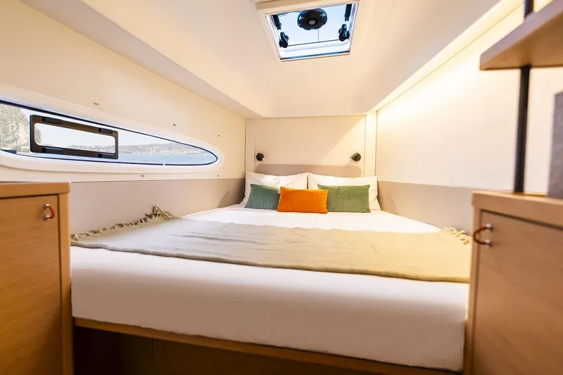 Slide: The Image of Manufacturer Provided Image: Luxurious cabin interior of 2026 Excess 13 yacht with cozy bedding and natural light. - 11