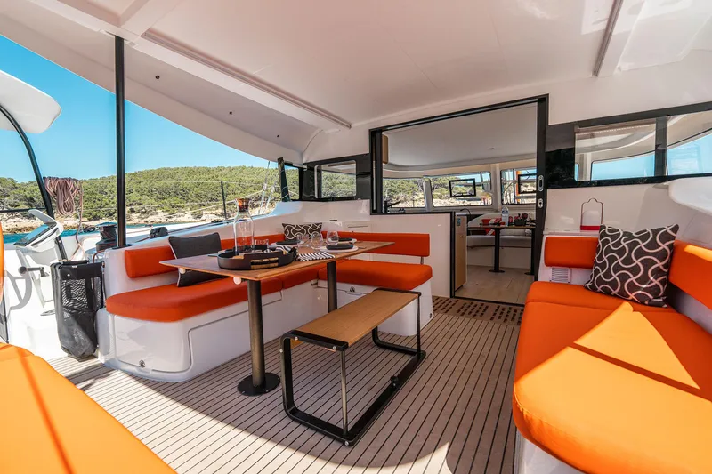 Slide: The Image of Luxurious 2026 Excess 13 yacht interior with vibrant orange seating and modern design. - 15