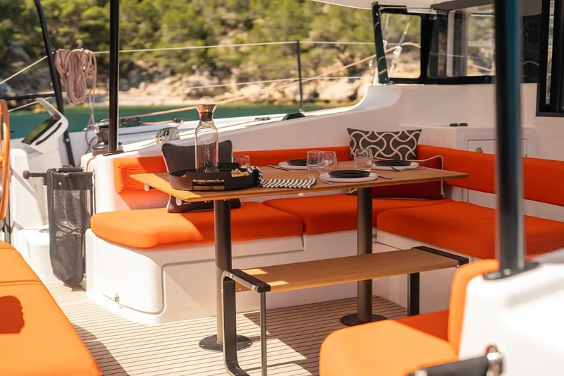 Slide: The Image of Manufacturer Provided Image: Luxurious 2026 Excess 13 yacht interior with vibrant orange seating and elegant dining setup. - 11