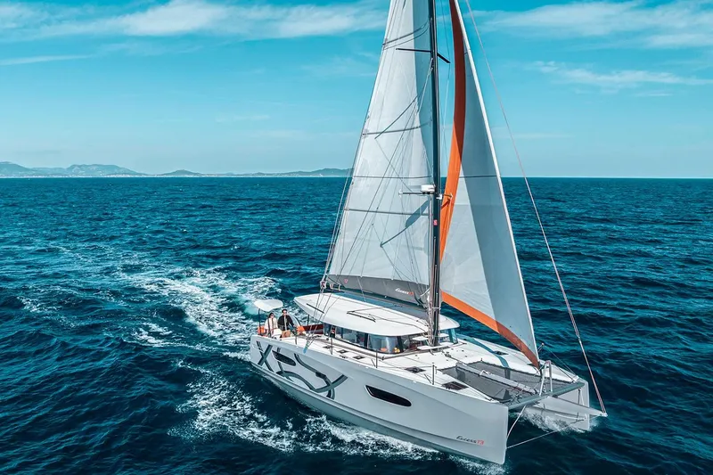 Slide: The Image of Manufacturer Provided Image: Sailing catamaran Excess 13, 2026 model, cruising on open sea under clear blue skies. - 6