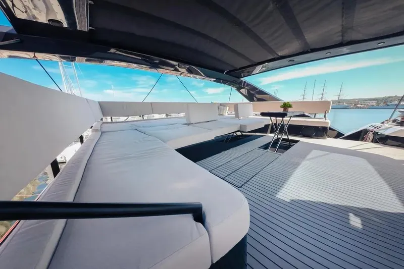 Slide: The Image of Luxurious 2024 Wave60 yacht deck with modern seating and cityscape backdrop. - 14