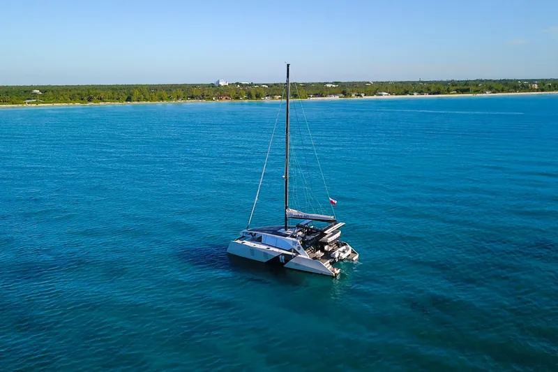 Slide: The Image of 2024 Wave Wave60 catamaran with solar panels on turquoise water. - 2