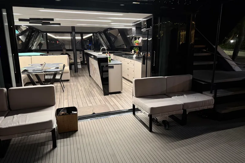 Slide: The Image of Luxurious 2024 Wave Wave60 yacht interior with modern kitchen and seating area at night. - 31