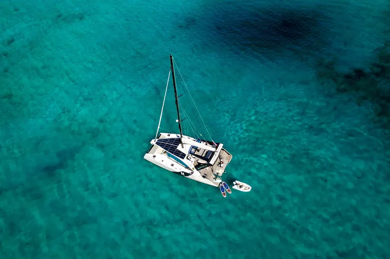 Slide: The Image of Aerial view of 2024 Wave Wave60 catamaran on clear turquoise water. - 36