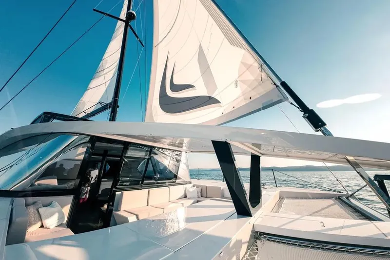 Slide: The Image of 2024 Wave Wave60 catamaran sailing on clear turquoise waters. - 6