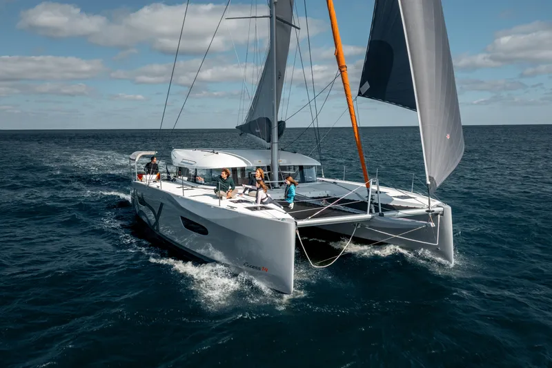 Slide: The Image of Sailing catamaran Excess 14, 2026 model, cruising on open sea under clear skies. - 4