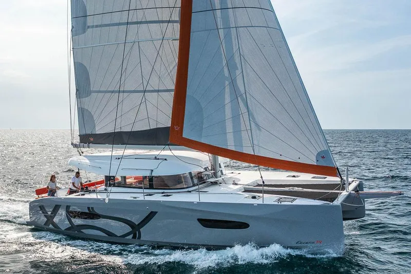 Slide: The Image of Manufacturer Provided Image: 2026 Excess 14 catamaran sailing on open sea with modern design and vibrant sails. - 2