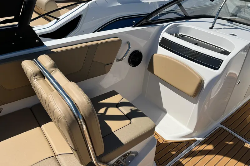 Slide: The Image of 2026 Bayliner VR6 Bowrider OB interior with tan seating and sleek dashboard design. - 10