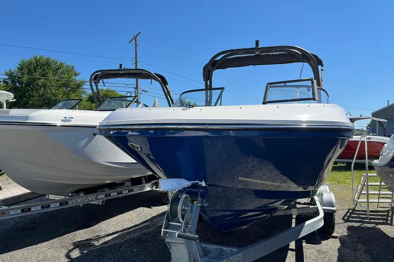 Slide: The Image of 2026 Bayliner VR6 Bowrider OB on trailer, sunny day, blue and white design. - 4