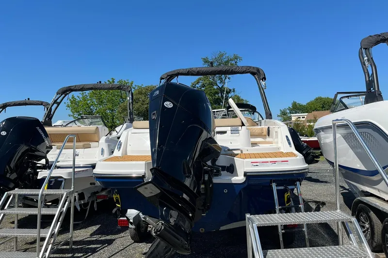 Slide: The Image of 2026 Bayliner VR6 Bowrider OB with outboard motor, displayed outdoors under clear blue sky. - 6