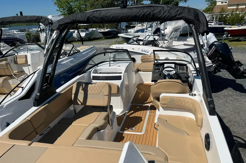 Slide: The Image of 2026 Bayliner VR6 Bowrider OB with spacious seating and modern design in a marina setting. - 7