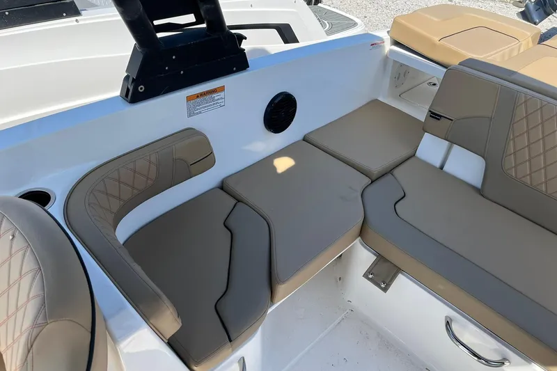 Slide: The Image of 2026 Bayliner VR6 Bowrider OB interior seating with beige cushions and diamond stitching. - 11