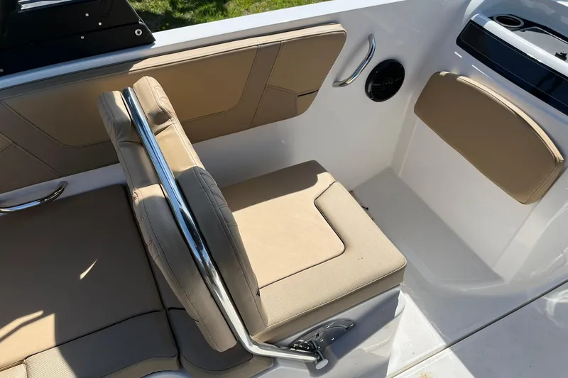 Slide: The Image of 2026 Bayliner VR6 Bowrider OB interior with beige seating and stainless steel accents. - 12
