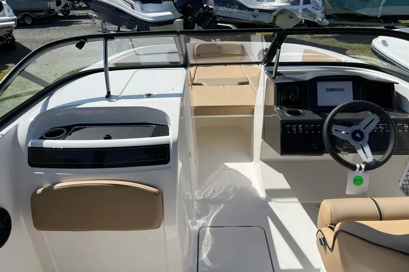 Slide: The Image of 2026 Bayliner VR6 Bowrider OB interior with steering wheel and dashboard controls. - 14