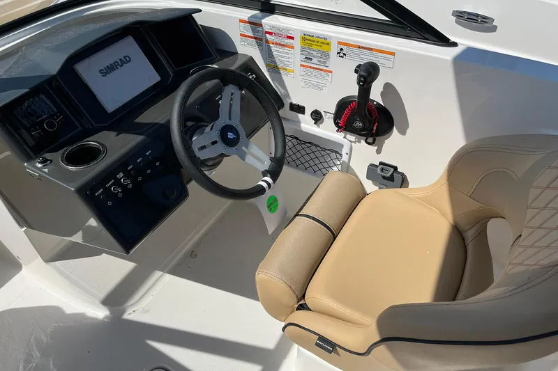 Slide: The Image of 2026 Bayliner VR6 Bowrider OB cockpit with steering wheel and control panel. - 16