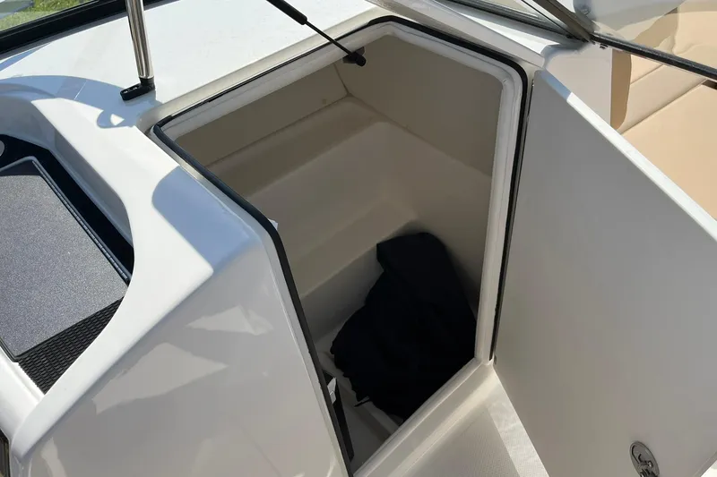 Slide: The Image of 2026 Bayliner VR6 Bowrider OB storage compartment with open hatch and interior view. - 18