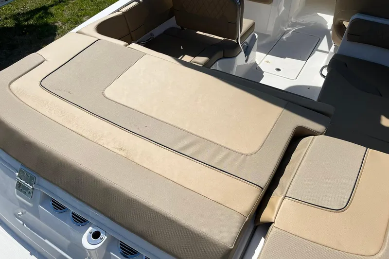 Slide: The Image of 2026 Bayliner VR6 Bowrider OB interior with beige seating and sun pad. - 9