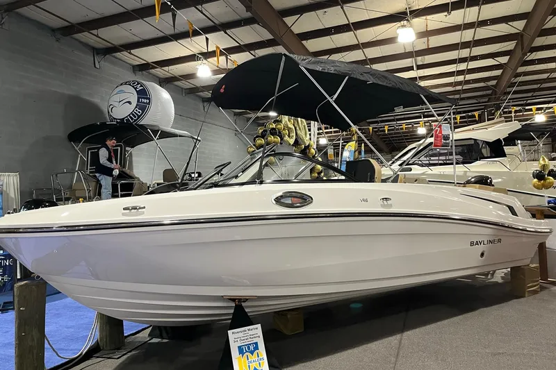 The Image of 2026 Bayliner VR6 Bowrider OB displayed at indoor boat show. - 0