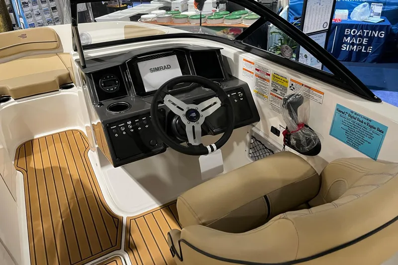 Slide: The Image of 2026 Bayliner VR6 Bowrider OB cockpit with Simrad display and tan seating. - 10