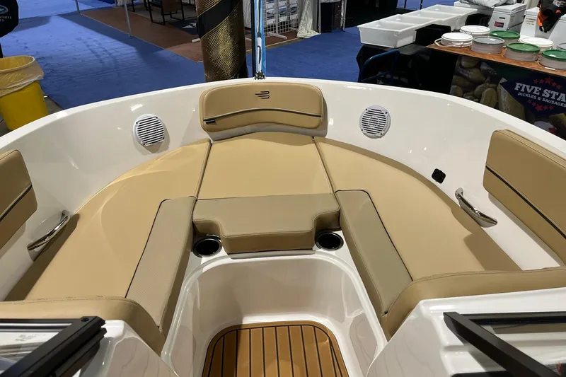 Slide: The Image of 2026 Bayliner VR6 Bowrider OB interior with tan seating and cup holders. - 11