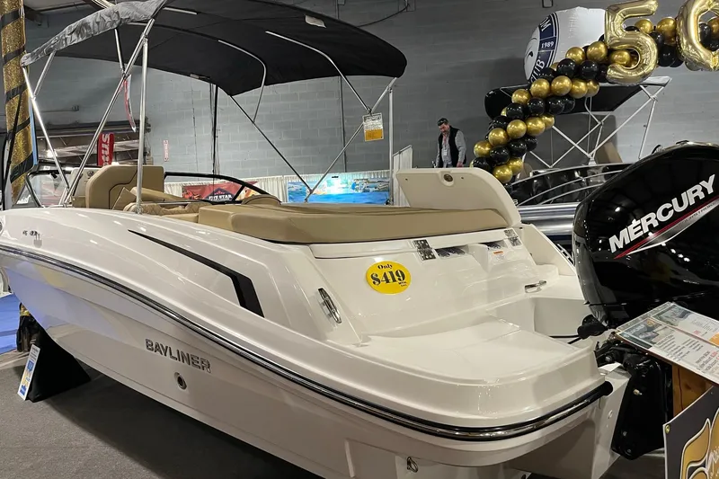 Slide: The Image of 2026 Bayliner VR6 Bowrider OB with Mercury engine at a boat show display. - 2