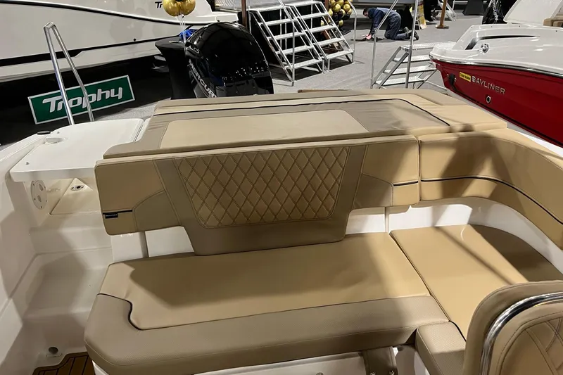 Slide: The Image of 2026 Bayliner VR6 Bowrider OB with tan seating at a boat show display. - 4