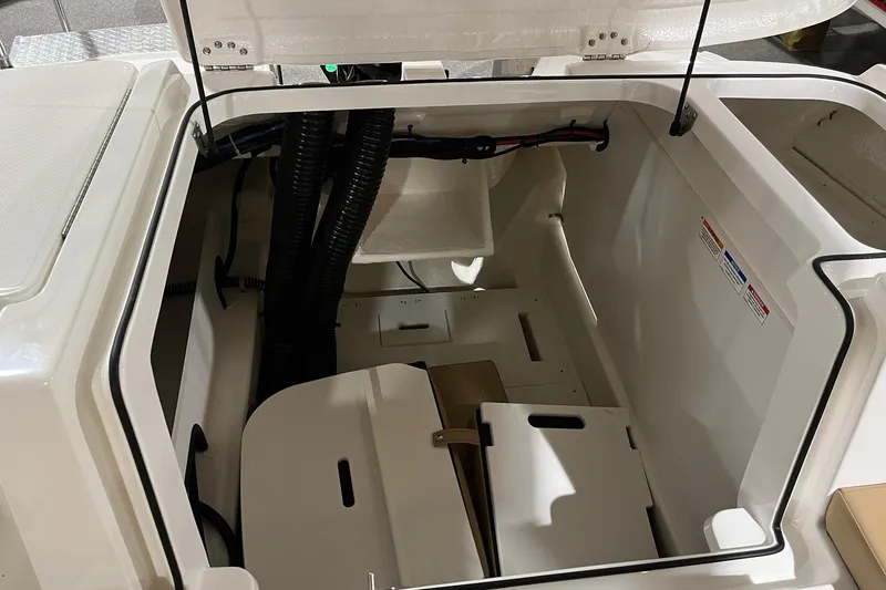 Slide: The Image of 2026 Bayliner VR6 Bowrider OB storage compartment with open hatch and visible wiring. - 5