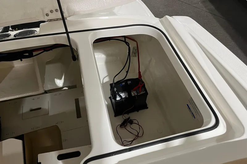 Slide: The Image of 2026 Bayliner VR6 Bowrider OB battery compartment with wiring and storage space. - 6