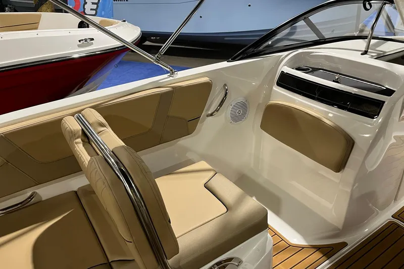 Slide: The Image of 2026 Bayliner VR6 Bowrider OB interior with tan seating and sleek design. - 8