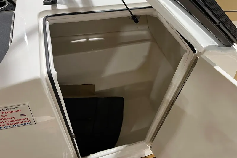 Slide: The Image of 2026 Bayliner VR6 Bowrider OB storage compartment with open hatch, showcasing interior space. - 9