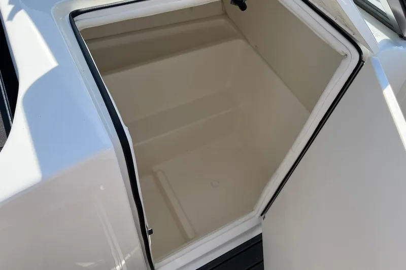 Slide: The Image of Storage compartment of 2026 Bayliner VR6 Bowrider OB boat, open and empty. - 15