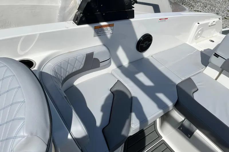 Slide: The Image of 2026 Bayliner VR6 Bowrider OB interior with gray seating and speaker detail. - 8