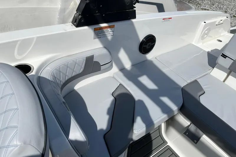 Slide: The Image of 2026 Bayliner VR6 Bowrider OB interior with cushioned seating and speaker system. - 9