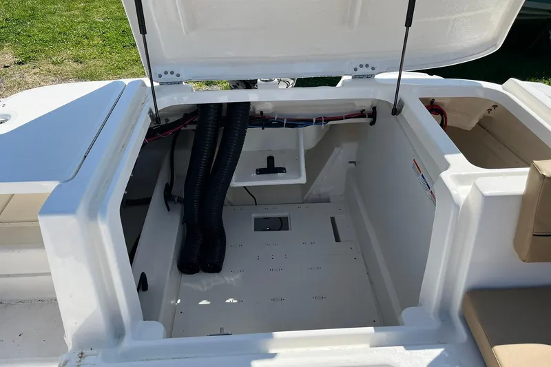 Slide: The Image of Open storage compartment of 2026 Bayliner VR6 Bowrider OB boat. - 11