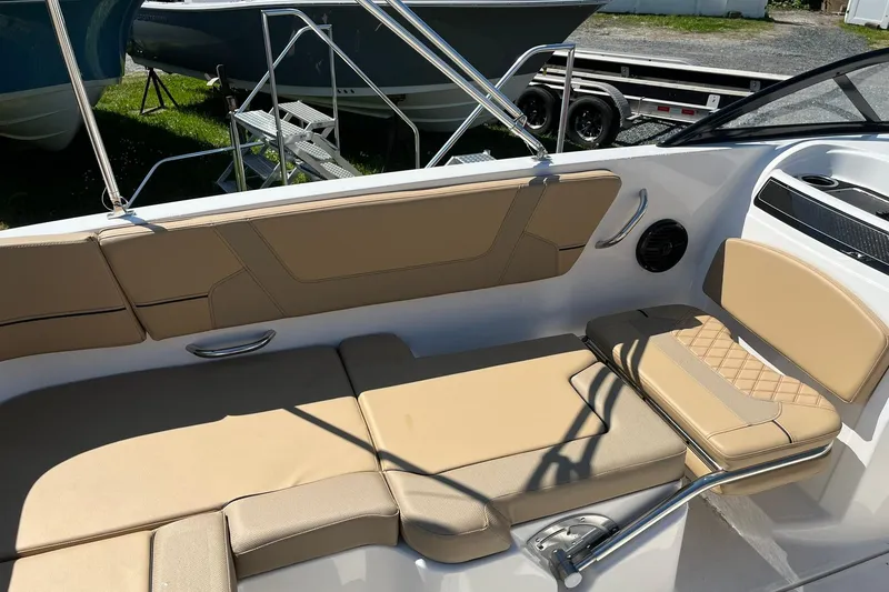 Slide: The Image of 2026 Bayliner VR6 Bowrider OB interior with beige seating and sleek design. - 12