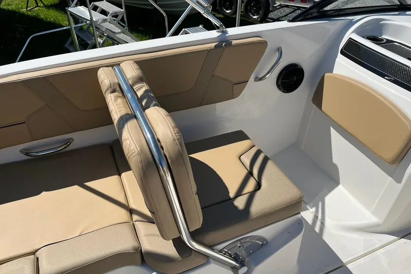 Slide: The Image of 2026 Bayliner VR6 Bowrider OB interior with beige seating and stainless steel handrail. - 13