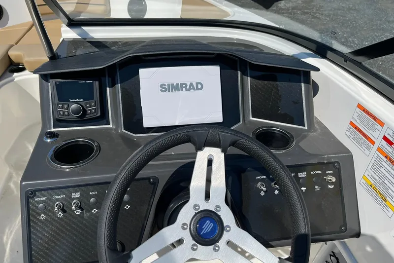 Slide: The Image of 2026 Bayliner VR6 Bowrider OB dashboard with Simrad display and control panel. - 16