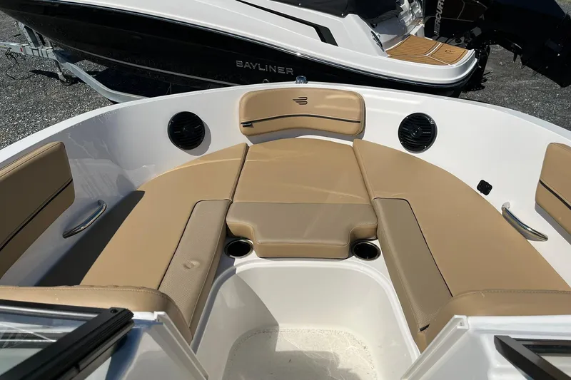 Slide: The Image of 2026 Bayliner VR6 Bowrider OB interior with tan seating and cup holders. - 18