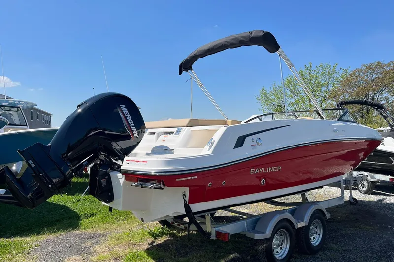 Slide: The Image of 2026 Bayliner VR6 Bowrider OB with Mercury outboard engine on trailer, sunny day. - 4